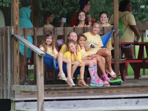 a group of children sitting on a wooden bench