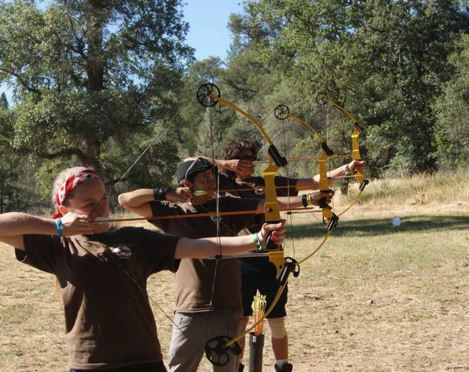 a group of people shooting bows