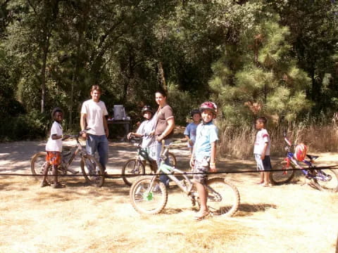 a group of people with bicycles