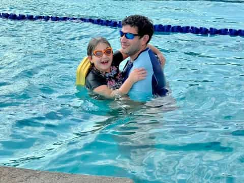 a person and a child in a pool