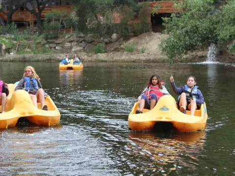 a group of people in inner tubes on a river