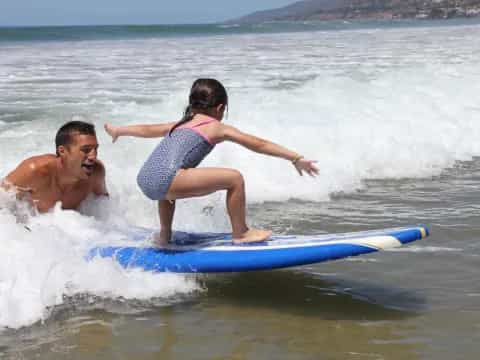 a man and a woman surfing