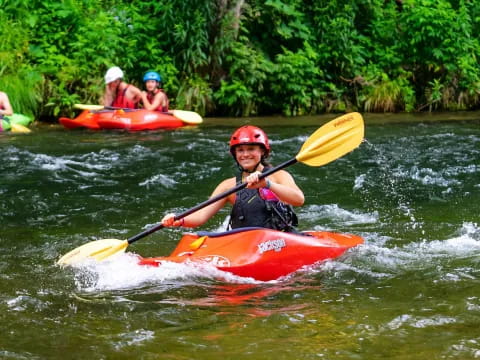 a group of people in kayaks on a river