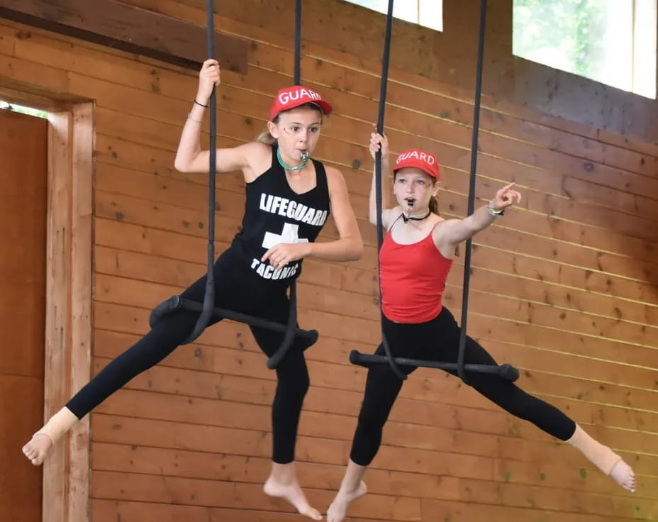 two women wearing helmets and dancing