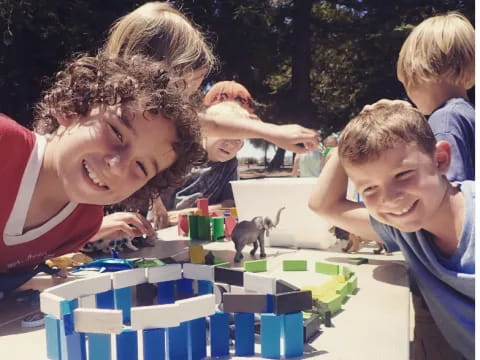 a group of boys playing with a building blocks