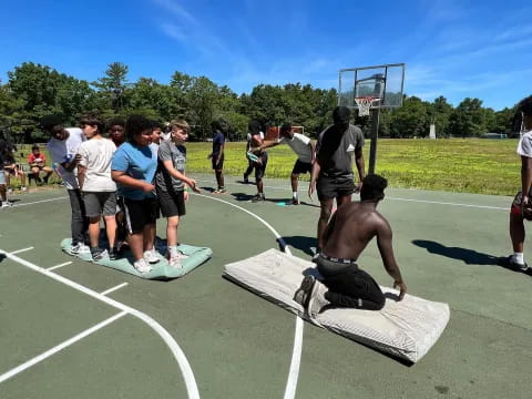 a group of people watching a person play basketball