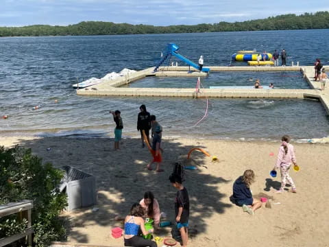 a group of people playing on a beach