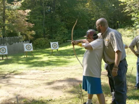 a group of men holding a bow and arrow