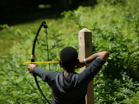 a person shooting a bow and arrow