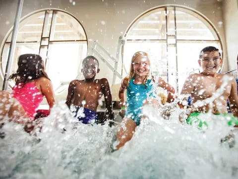 a group of kids playing in water