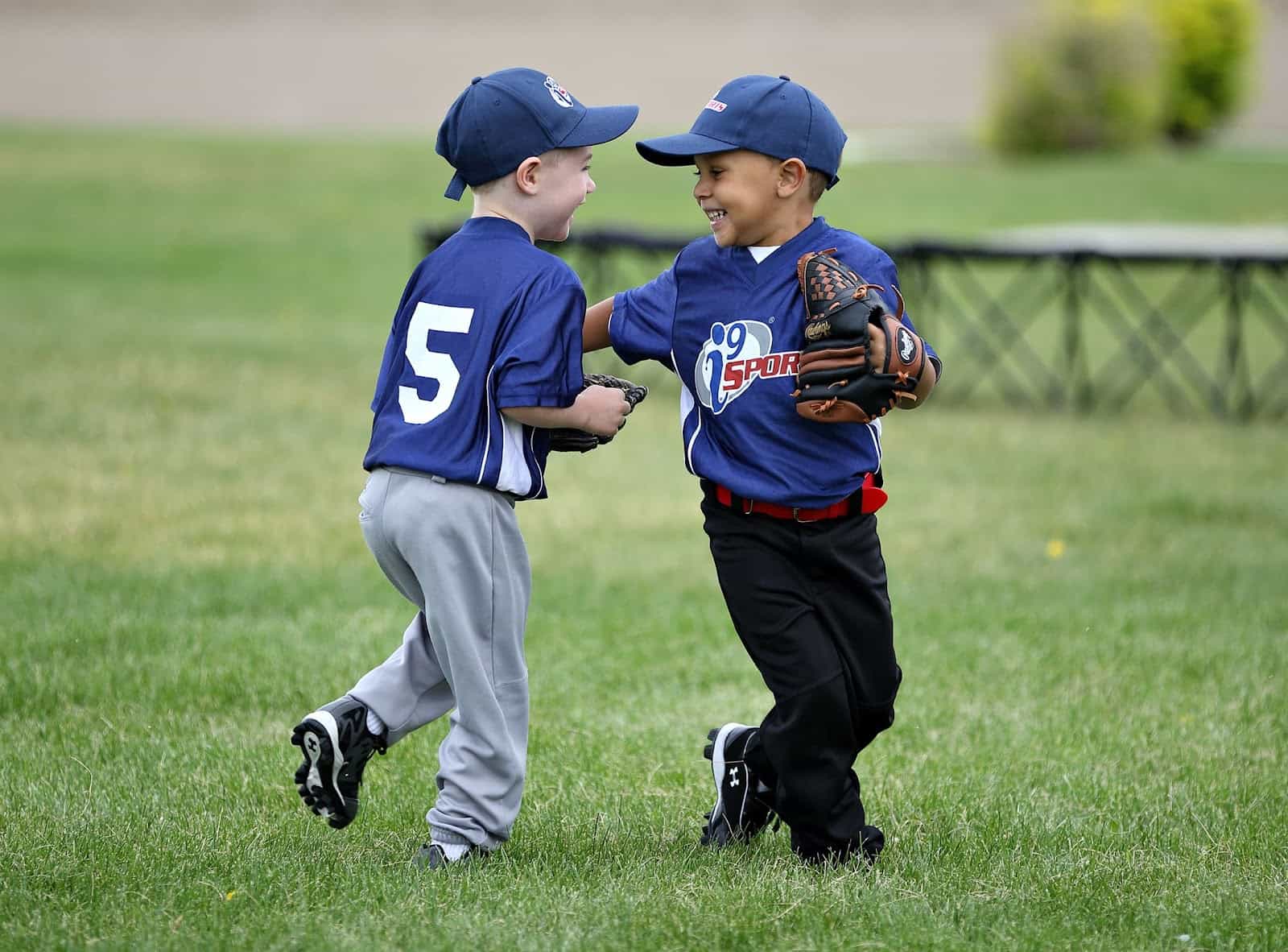 a couple of young boys playing baseball