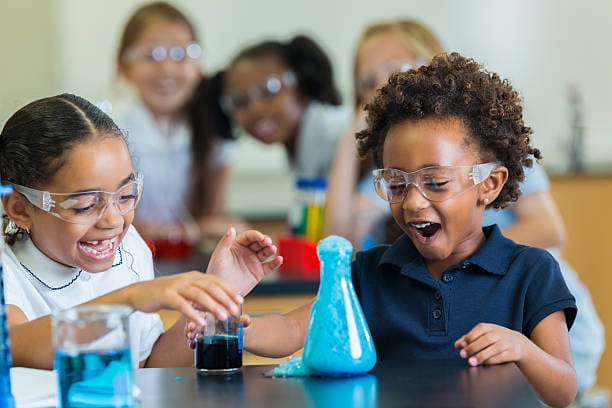 medium shot of kids looking at a device