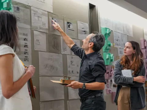 a man showing a woman something on a white board