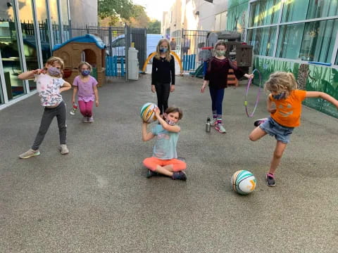 a group of kids playing with a ball