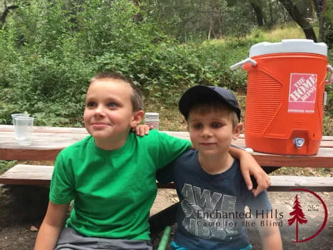 two boys sitting on a bench