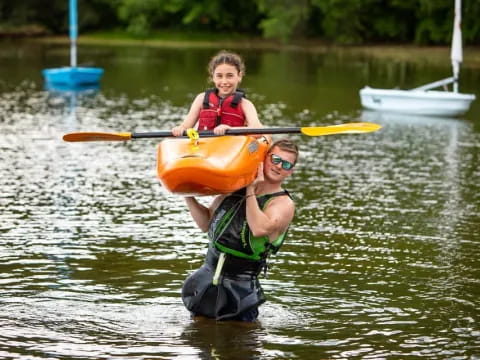 a person and a boy in a kayak