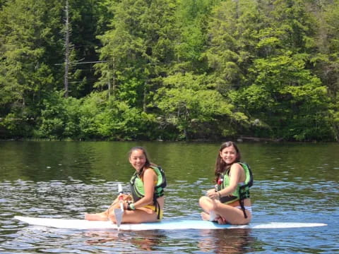 two girls on a paddle board