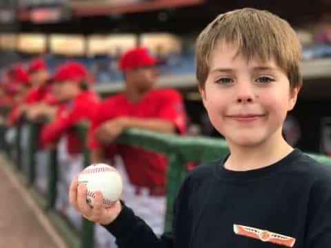 a boy holding a baseball
