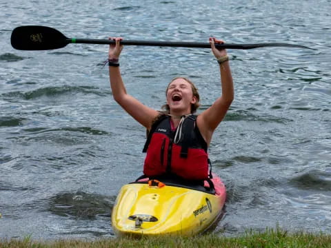 a man in a kayak holding a paddle