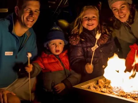 a group of people posing for a photo with a fire