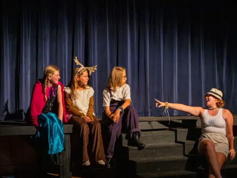 a group of women sitting on a stage