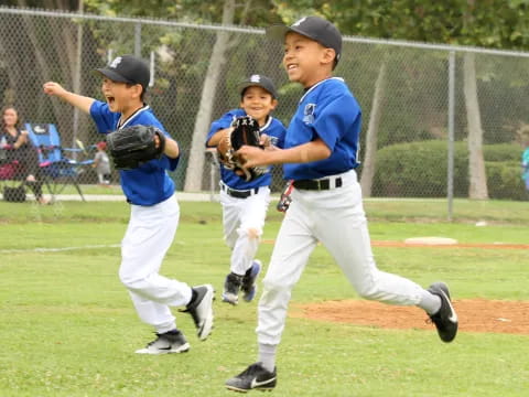 a group of kids playing baseball