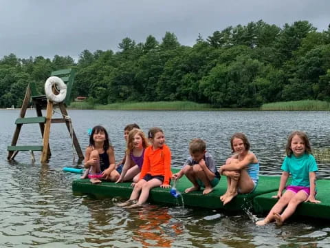 a group of kids in a canoe