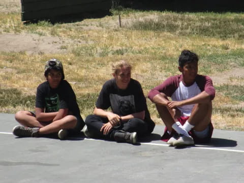 a group of men sitting on the ground