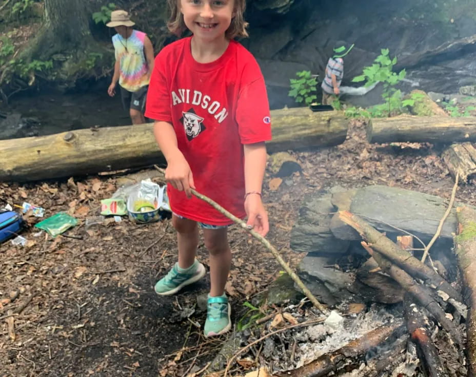 a girl standing on a log