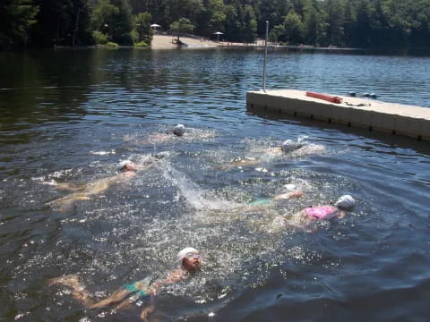 a group of people swimming in a lake