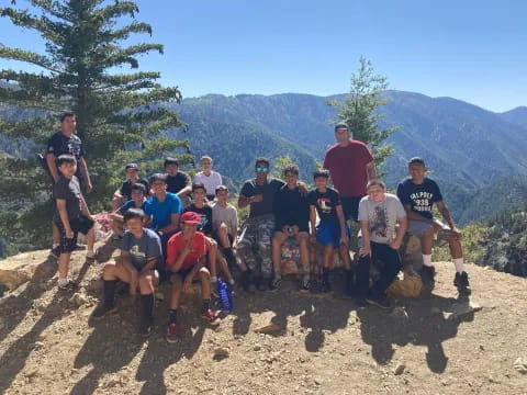 a group of people posing for a photo on a mountain