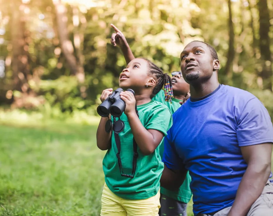 a man and a woman taking a picture in a park