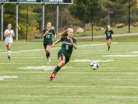 girls playing football on a field