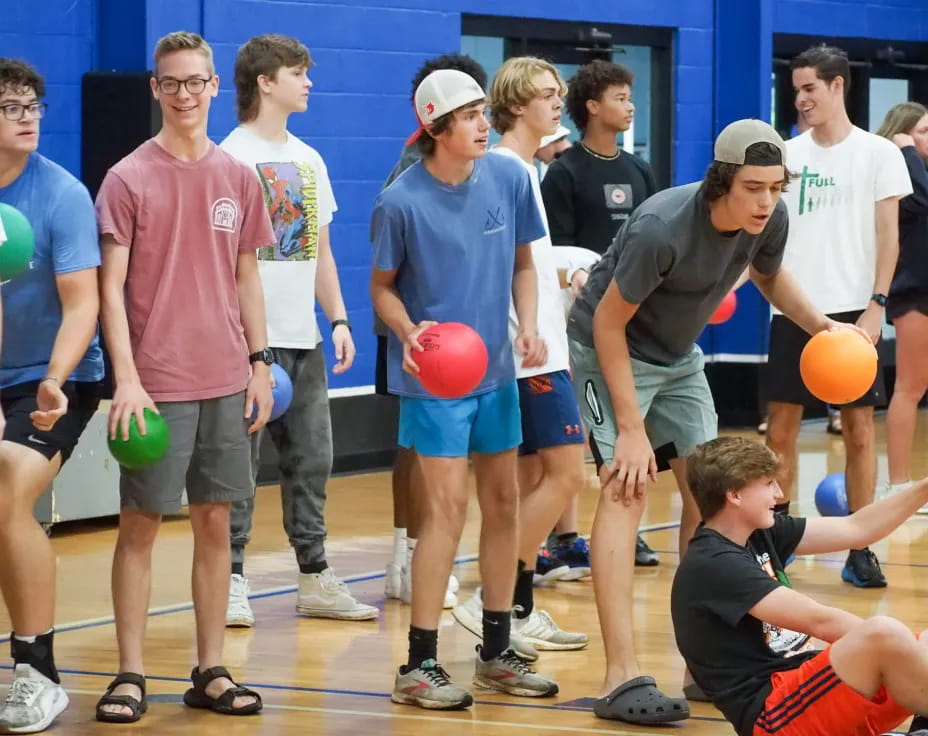 a group of people holding balls