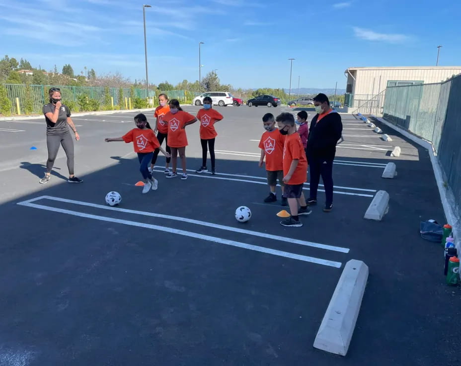 a group of kids playing football