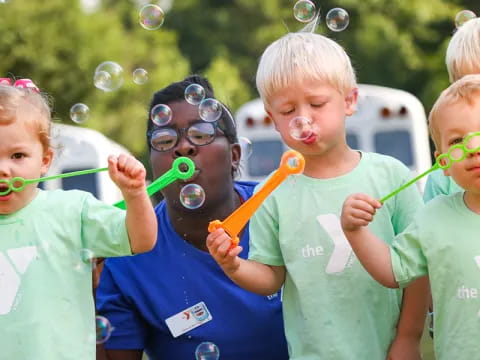 a group of children playing with bubbles