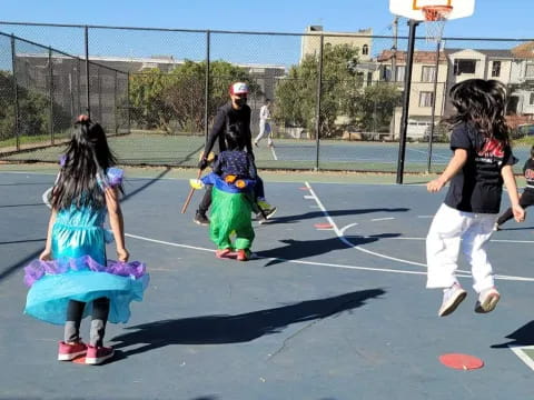 a group of people playing basketball