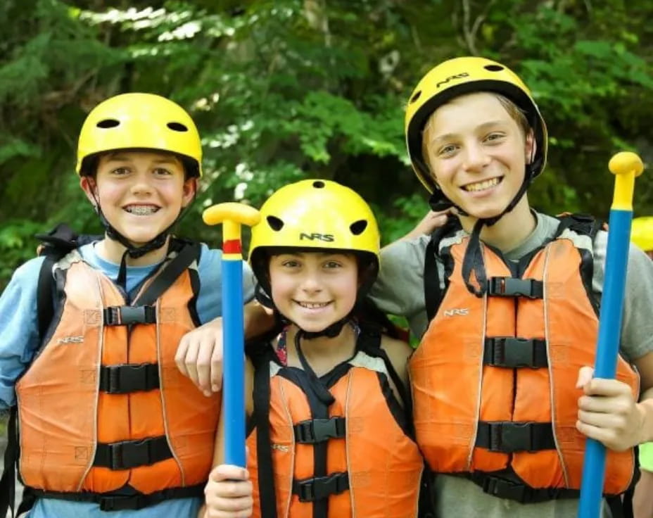 a group of people wearing helmets and holding bats