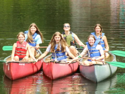 a group of people in canoes