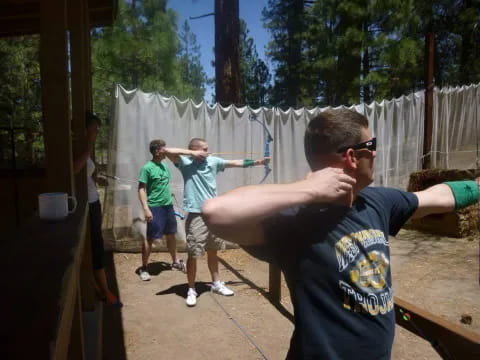 a group of people playing with a toy gun