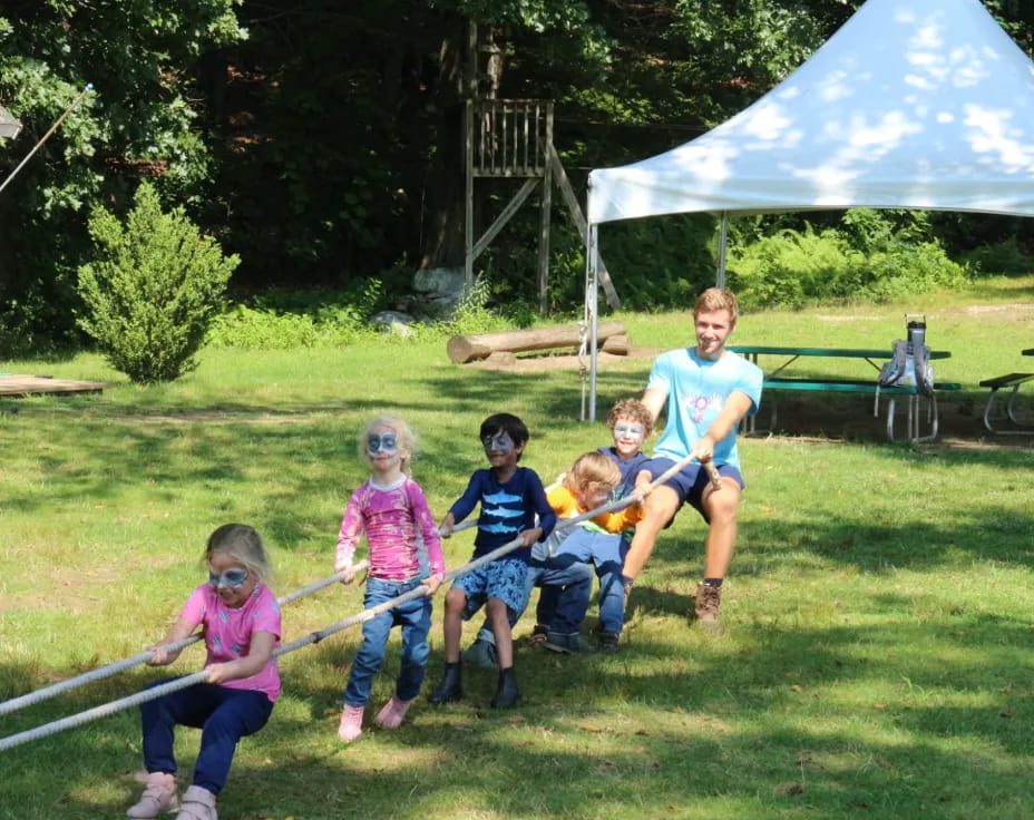 a group of people sitting on grass