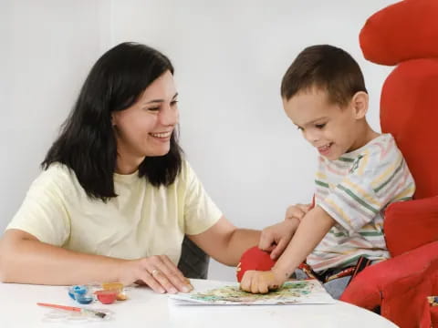 a person and a child sitting at a table