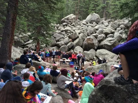 a group of people sitting on rocks