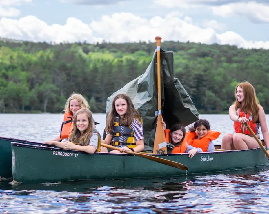 a group of people in a canoe