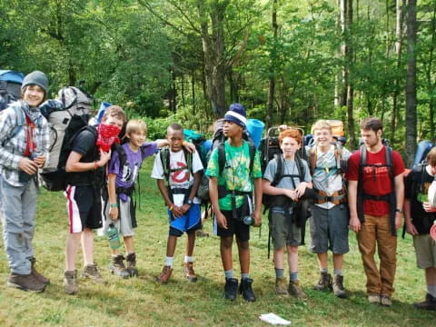 a group of people standing in a forest