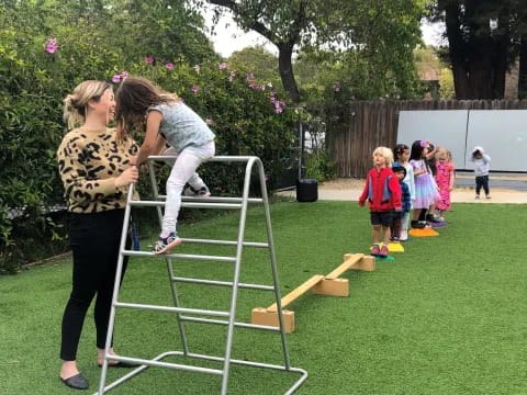 a person and a child playing on a play set