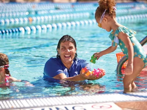 a person and two children in a pool