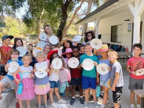 a group of children holding frisbees