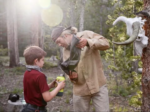 a man and a boy looking at a large animal