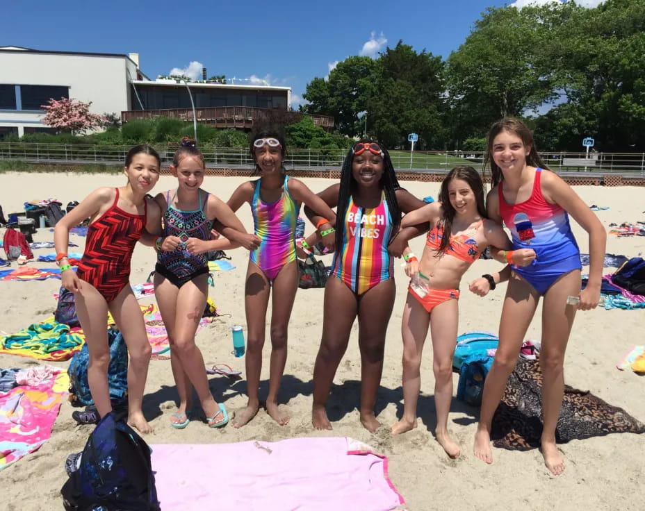 a group of women in garments on a beach